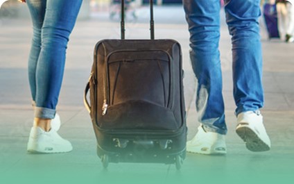 Travelers with luggage walking through an airport terminal heading to their destination together