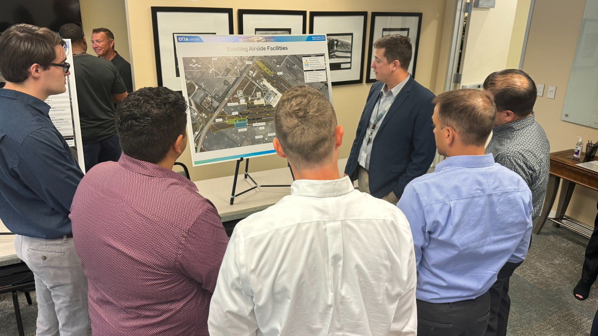 Airport administrator showing an aerial map to a group of men