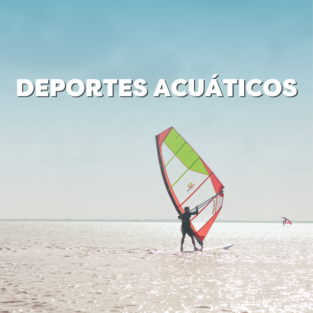 Person enjoying windsurfing on a sunny day with bright colorful sail over calm waters under blue sky.