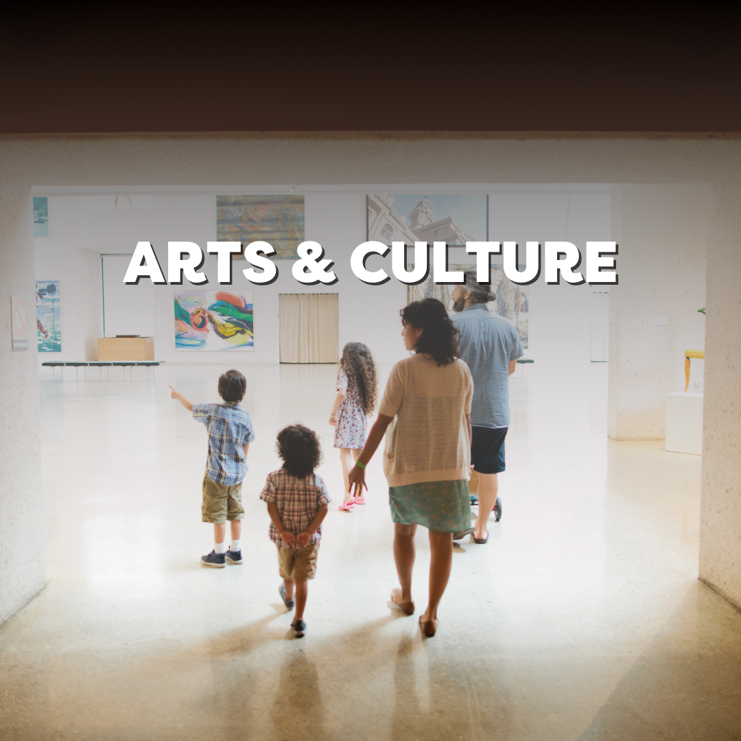Family exploring art gallery with children in a brightly lit space focused on cultural and artistic exhibits