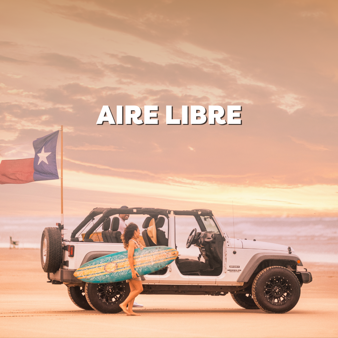 Surfer girl with surfboard stands by a Jeep on a sandy beach at sunset with a Texas flag waving gently