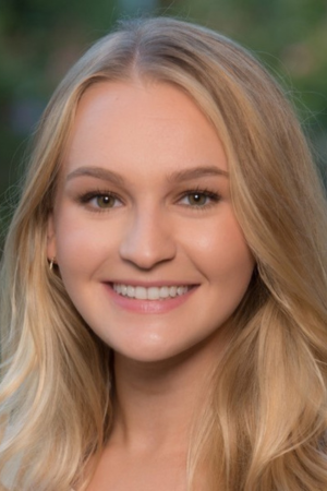 Professional headshot of Sara Azali against a dark background, smiling.