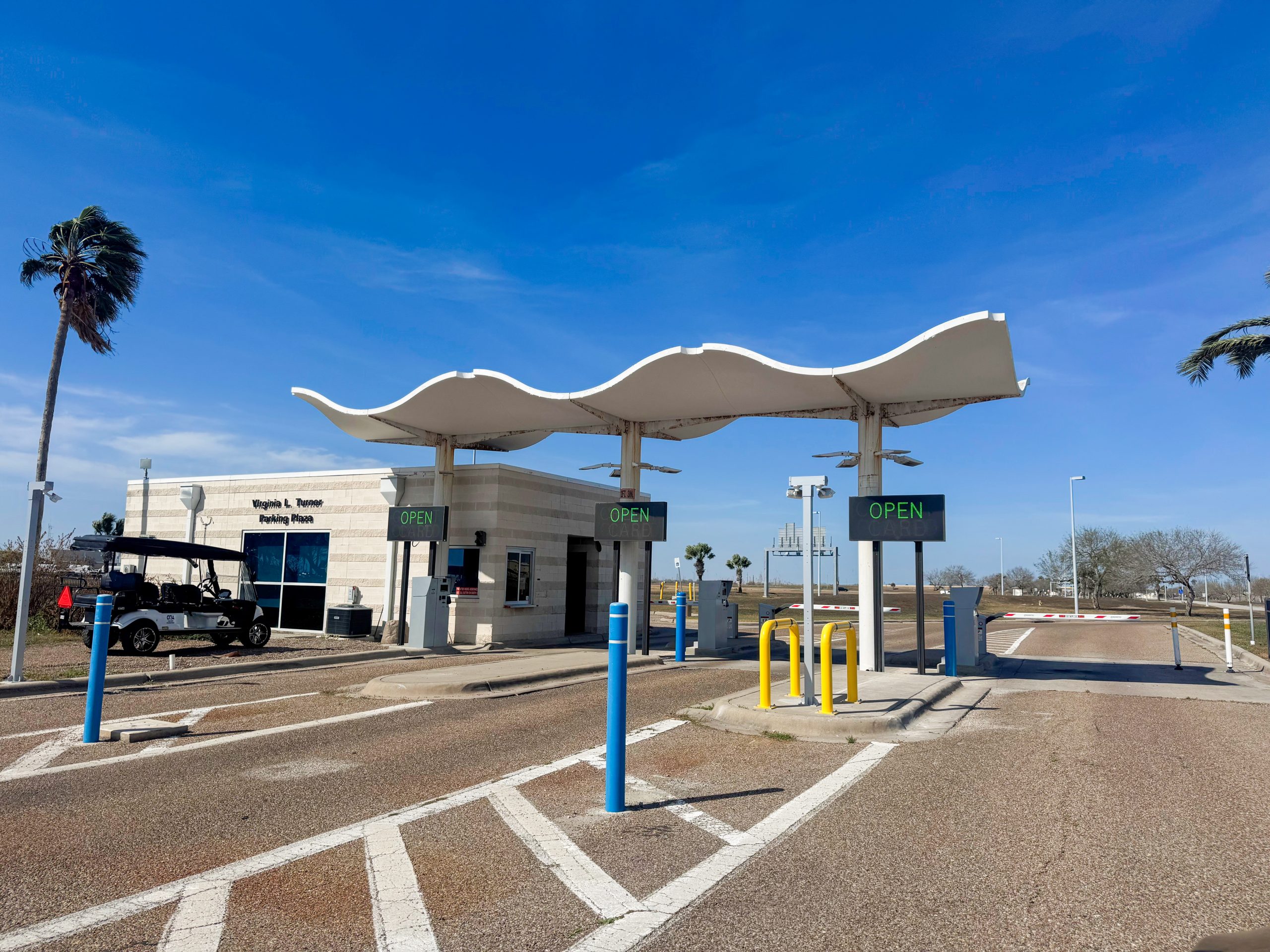 Photo of a pay station in the parking lot with the words "Pay here"